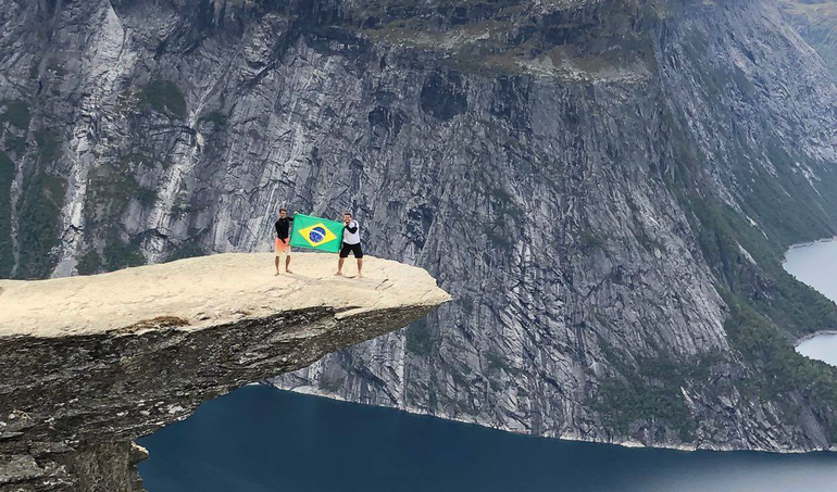 Me and my Brazilian friend with flip-flops and the Brazilian flag in Trolltunga! (Great day!)