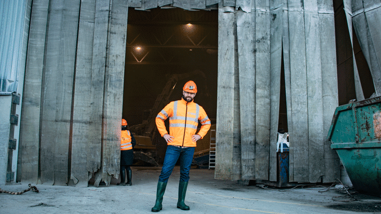 Ingeniørstudent Lars Grøstad poserer foran KMT Gjenvinnings granuleringsanlegg. Foto