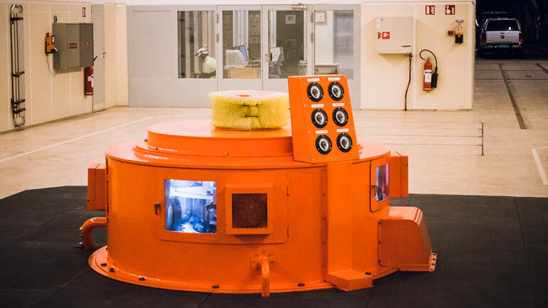 Picture of a orange hydropower generator.