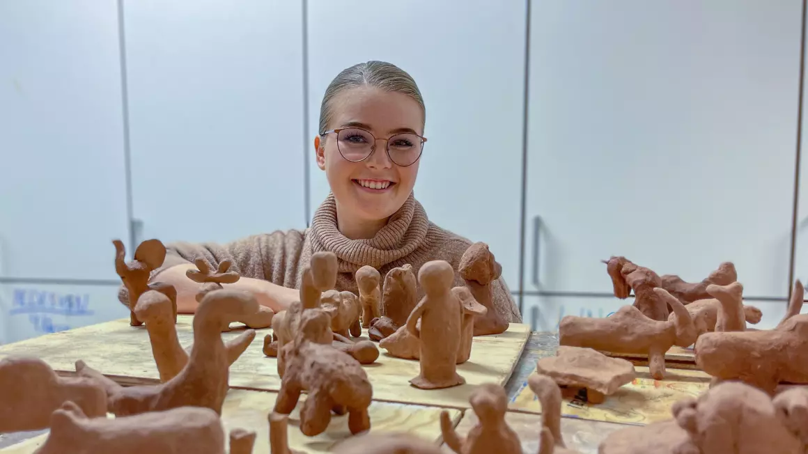 Lærer foran keramikk i klasserom