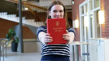 Emilie Ødegård Kjørvik studerer jus på campus Ringerike og holder opp Norges Lover