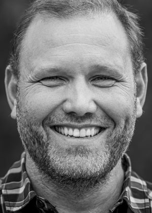 Portrett av Carl-Magnus Nystad som ser i kamera og smiler