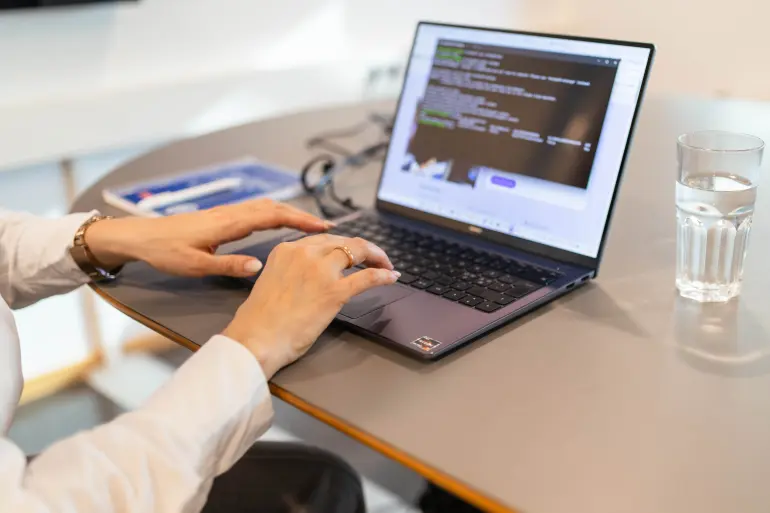 Bilde av hender på et tastatur ved PC