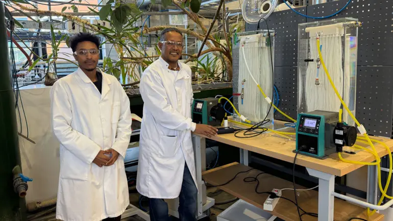 scientists in lab in front of experiment