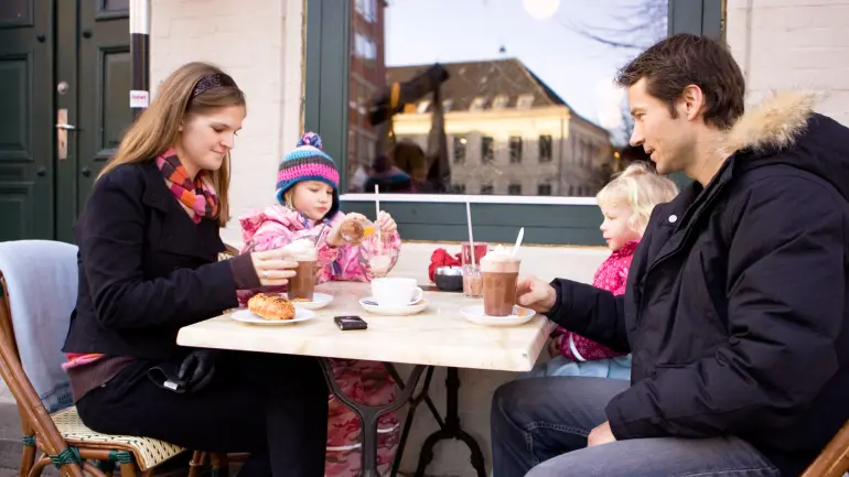 Familie ved et cafebord utendørs