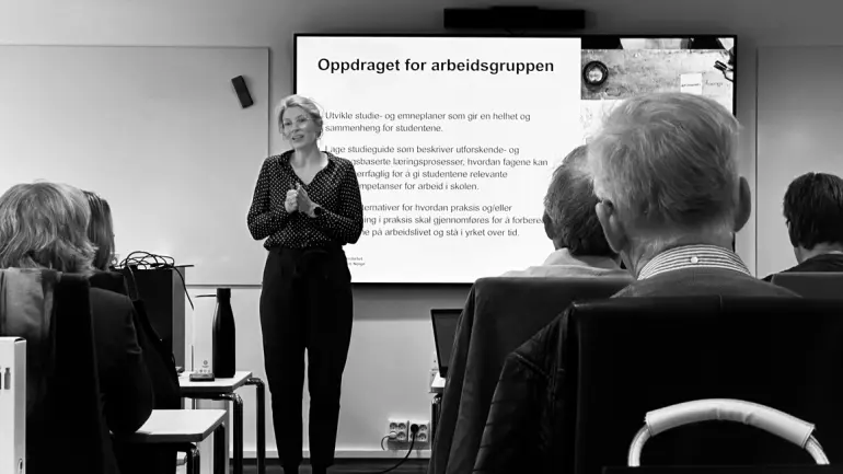 Sigrun snakker foran klasserom med mennesker