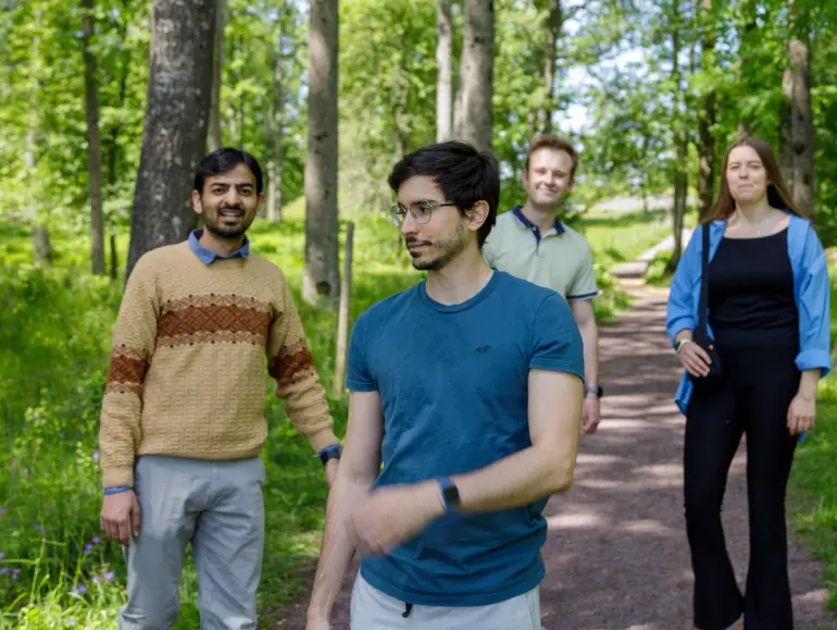 students outside on a path in the woods
