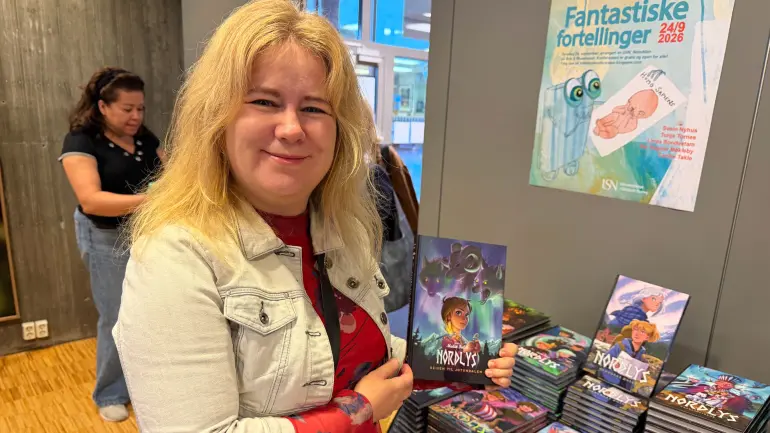 Redaktør Tonje Tornes viser fram Nordlys-bok 